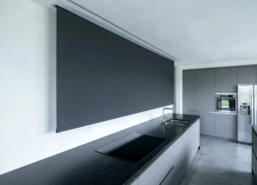 Blind dropping from a slim concealed ceiling recess above a kitchen window