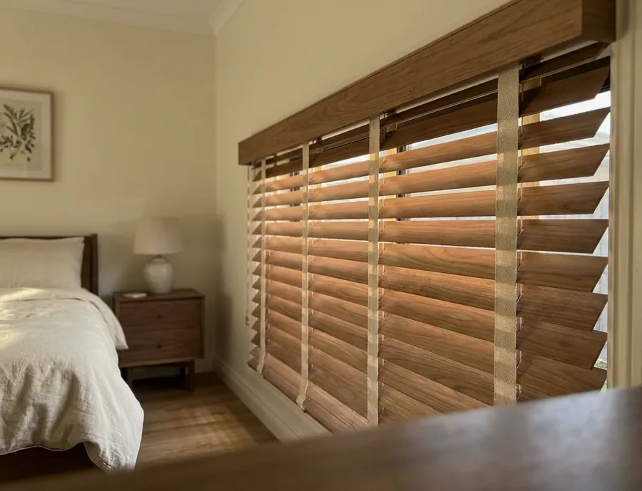 Timber venetian blind with wide slats and tapes in a character bedroom